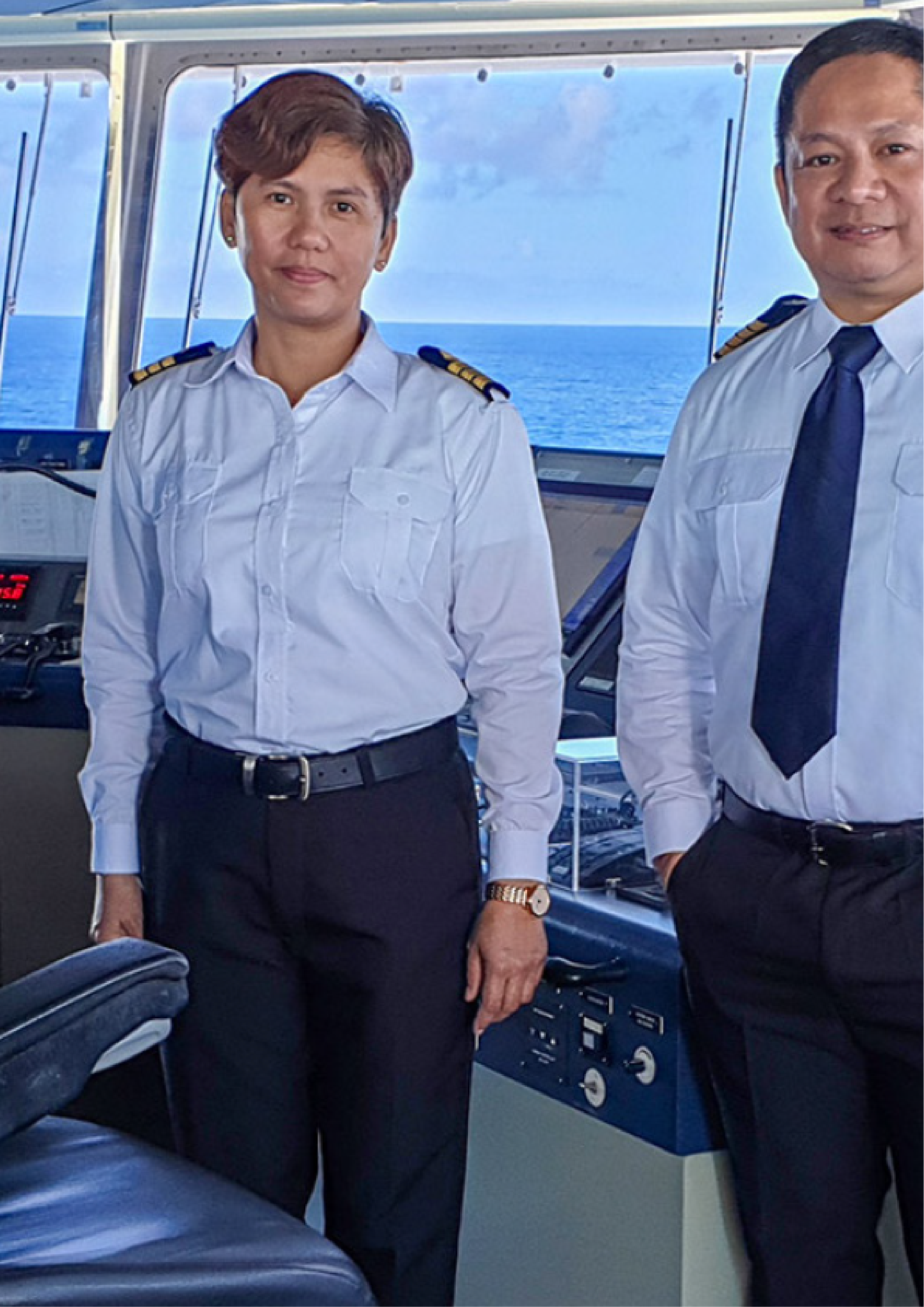 Two captains standing in the bridge of a ship.