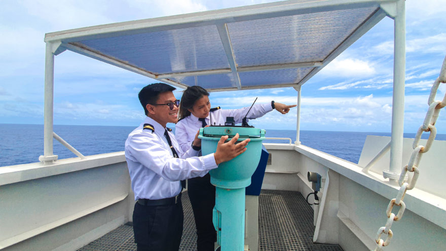 Two of our employees at Grieg Philippines pointing at something in the distance.