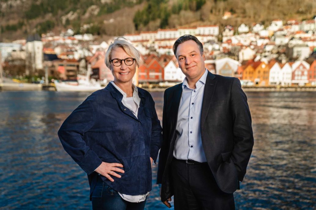 Elisabeth Grieg and Matt Duke standing in the front of Bergen Harbour.