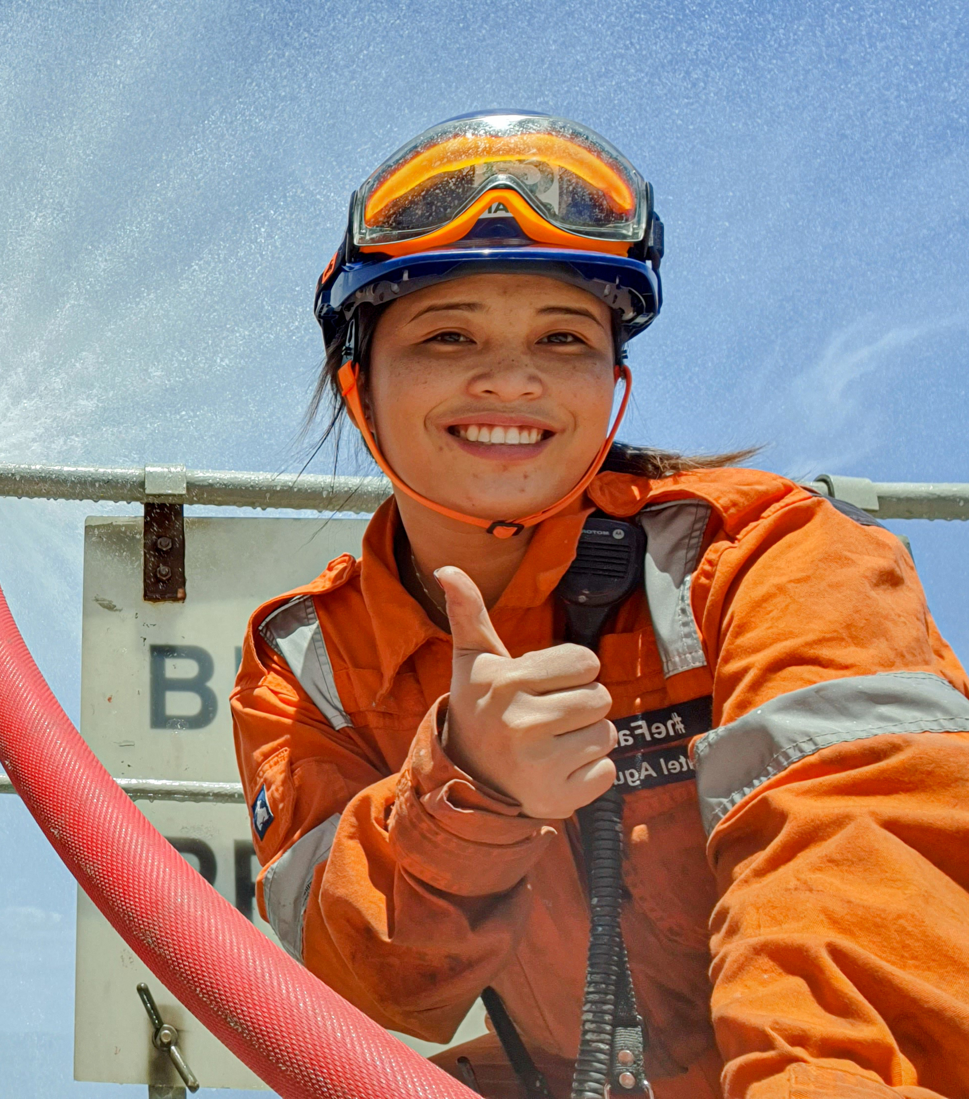 A female employee giving thumbs up to the camera.