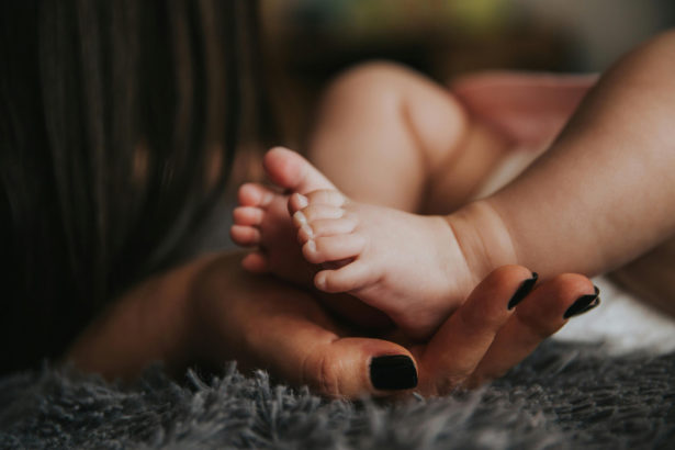 Baby's feet held up by a woman's hand